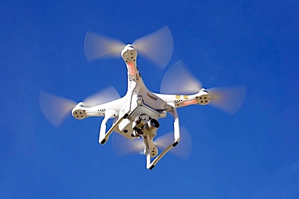A drone flying in the deep blue sky.