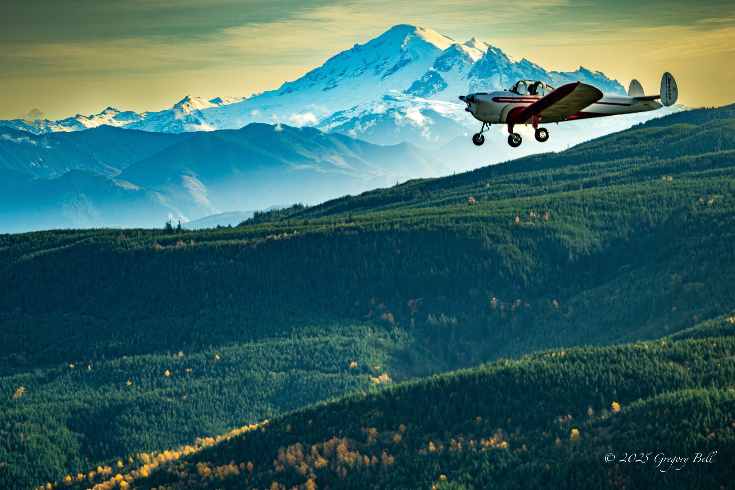 1946 Ercoupe flying by Mount Baker in Washington State Picture of the Day